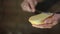 Woman hands spreading butter on bread, slow motion