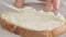 Woman hands spreading cream cheese on bread