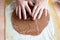 Woman hands squeeze christmas shapes gingerbread cookie from the dough.