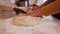 Woman hands stretch the bread dough preparing to fold it