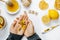 Woman hands with tablets, tea, lemon, thermometer, ginger, hon