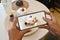Woman hands takes photography of dessert with phone. Pancake and strawberry with cream. mobile photo for post.