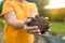 Woman hands touching soil on the field. Expert hand of farmer checking soil health before growth a seed of vegetable or