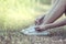 Woman hands tying lace her old shoes ready for travel