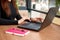 Woman hands type long text on keypad on laptop. Cropped view of office worker sitting at table in cafe