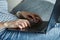 Woman hands typing on laptop keyboard