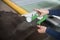 Woman hands use Leather thickness gauge on with a natural brown leather. Preparing of the raw materials for manufacture