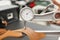 Woman hands use Leather thickness gauge on with a natural brown leather. Preparing of the raw materials for manufacture