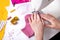 Woman hands using a sewing machine to sew a pink ladies face mask during the coronavirus pandemia.