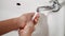 Woman hands using soap and washing hands under the water tap