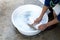 Woman hands wash dirty clothes with brush