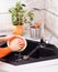 Woman hands wash dish with sponge in modern kitchen