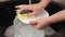 Woman hands wash plate at the kitchen sink, slow motion