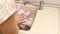 Woman hands washing, cleaning raw pink chicken properly in sink in the kitchen. Food preparation, cooking meat hygiene