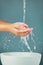 Woman hands, water splash with sink, washing and skin  on studio background, hygiene and skincare with beauty