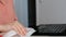 Woman hands wiping laptop keyboard with disinfectant wet wipe. Desinfection