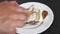 woman hands with wooden kife are Spreading soft butter on a piece of bread.