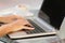 Woman hands working with a laptop in a coffee shop