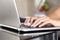 Woman hands working with a laptop at home