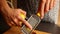 Woman hands zesting a lemon closeup