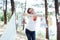 Woman hanging baby clothes in linen rope outdoors