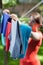 Woman hanging clothes on laundry line in garden