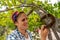 Woman hanging a horseshoe on a tree branch