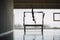 Woman hanging upside down and exercising on a Pilates Trapeze table Machine