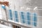 Woman hangs some surgical masks to dry in the sun