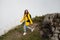 Woman happily running on the top of the moutain surrounded by the cloud