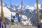 A woman happily swings on a swing high in the mountains