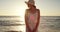 Woman, happy and beach in sunset, summer and enjoy the ocean, nature and seaside. Travel, holiday and smile for vacation