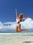 woman happy jumping relaxing on tropical beach send