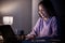 Woman, happy or laptop typing in night studying, education or homework research in living room on elearning website