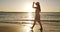 Woman, happy and ocean in sunset, summer and enjoy the beach, nature and seaside. Travel, holiday and smile for vacation