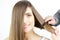 Woman happy smiling getting long hair combed by hairdresser isolated