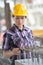 Woman in hardhat inspecting metal reinforcing bars