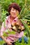 Woman harvesting onions in garden