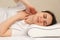 A woman has a sore neck after sleeping on the wrong uncomfortable pillow