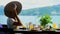 Woman in hat in cafe by the sea enjoy breakfast buffet or dinner