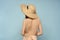 Woman in hat with naked back on blue background model back view
