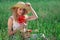 Woman in hat with poppy bouquet