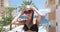 A woman in a hat sends a kiss at the camera against the background of the sea.