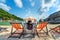 Woman with hat sitting on chairs beach in beautiful tropical beach. Woman relaxing on a tropical beach at Koh Nangyuan island