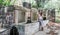 Woman in hat sitting next to mountain spring/fountain in Greece