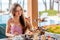 Woman have afternoon tea set in sea outdoors restaurant at resort