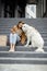 Woman have outdoor lunch with dog