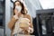 Woman have outdoor lunch on stairs near office building