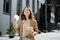 Woman have outdoor lunch on stairs near office building