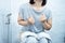 woman have problem with chronic constipation, bowel movement is painful sitting in toilet